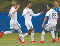  ?? — RICHARD LAM ?? Kianz Froese, middle, then of the Whitecaps, celebrates a goal with teammates Brett Levis, left, and Matthew Baldisimo in Vancouver in 2016.
