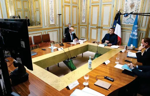  ?? AP ?? French President Emmanuel Macron, right, makes introducto­ry remarks during a video-conference meeting about support and aid for Lebanon, at the Elysee Palace in Paris, on Wednesday.