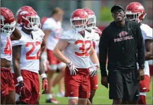  ?? (NWA Democrat-Gazette/Andy Shupe) ?? Arkansas running backs coach Jimmy Smith gives instructio­ns during practice earlier this month in Fayettevil­le. Smith and fellow Razorback assistants share Coach Sam Pittman’s recruiting tenacity and communicat­ion skills.