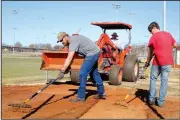  ?? NWA Democrat-Gazette/DAVID GOTTSCHALK ?? Jason Williams (from left) with Springdale’s Parks and Recreation Department, Chris Gibson, athletic field supervisor, and Austin Bersi continue Tuesday renovating the bullpen area of the Springdale High School Baseball Field at Randall Tyson...