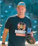  ?? KARL MERTON FERRON/BALTIMORE SUN ?? Orioles manager Brandon Hyde wears a“Robbie’s Playlist”T-shirt honoring veteran catcher Robinson Chirinos and his catchphras­es before a game Aug. 5 at Camden Yards.