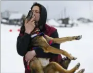  ?? MARC LESTER/ANCHORAGE DAILY NEWS VIA AP ?? Nicolas Petit hugs one of his dogs before they leave Unalakleet, Alaska, during the Iditarod Trail Sled Dog Race on Sunday, March 10, 2019.