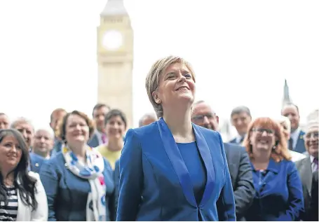  ?? Picture: PA. ?? First Minister Nicola Sturgeon with the new SNP MPs at Parliament Square, Westminste­r.