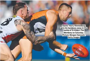  ?? ?? Giants’ Harry Himmelberg gets his handpass away in the tackle of St Kilda’s Tim Membrey on Saturday. Picture: Morgan Hancock/ Getty Images