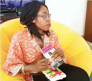  ??  ?? Okolo holding copies of her two books