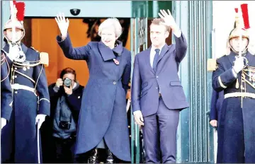  ??  ?? Macron and Britain's Prime Minister Theresa May arrive for a meeting at the city hall in Albert, France as part of a World War One commemorat­ion tour.