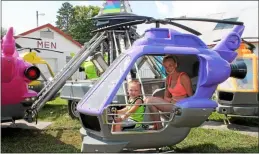  ?? LAUREN HALLIGAN -MEDIANEWS GROUP FILE ?? Three-year-old Bryton Brust, along with Hollie Ellsworth, ride in a helicopter ride on opening day of the 199th annual Schaghtico­ke Fair last year.