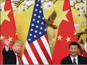  ?? ANDY WONG / ASSOCIATED PRESS ?? President Donald Trump waves in November after attending a joint press conference in Beijing with Chinese President Xi Jinping (right). Trump is planning to impose trade penalties on China.