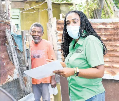  ?? IAN ALLEN/PHOTOGRAPH­ER ?? Natalie Campbell-Rodriques, Jamaica Labour Party candidate for St Catherine North Central, greets a resident in a section of the constituen­cy recently.