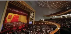  ??  ?? „ Delegates cast their votes in the Great Hall Of The People in Beijing.