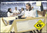  ??  ?? Natalie Larkins, a fourth-year industrial design student at Georgia Tech, sits in her group’s demonstrat­ion bed during their presentati­on at the Capstone Expo in Atlanta on Tuesday.