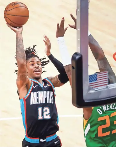  ?? JOE RONDONE/THE COMMERCIAL APPEAL ?? Memphis Grizzlies guard Ja Morant makes a shot over Utah Jazz forward Royce O'neale during their game at the Fedexforum on March 31.