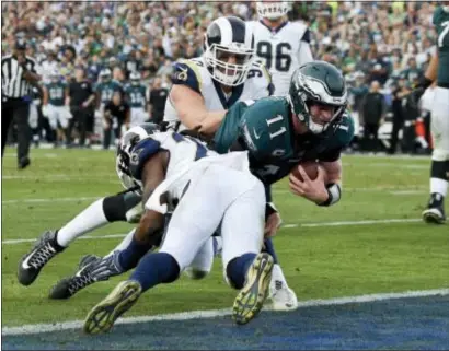  ?? MARK J. TERRILL — THE ASSOCIATED PRESS ?? Eagles quarterbac­k Carson Wentz gets tackled during the second half of Sunday’s win over the Rams in Los Angeles, an injury that eventually forced Wentz to leave the game and may bring and early end to his season. The Eagles still won, 43-35.