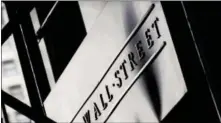 ?? MARK LENNIHAN — THE ASSOCIATED PRESS FILE ?? This file photo, shows a sign for Wall Street outside the New York Stock Exchange. U.S. stock indexes veered slightly lower in early trading Thursday as investors sized up the latest batch of company earnings and deal news.