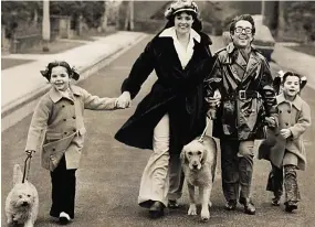  ??  ?? Walking tall: The couple with daughters Emma, left and Sophie in 19 4