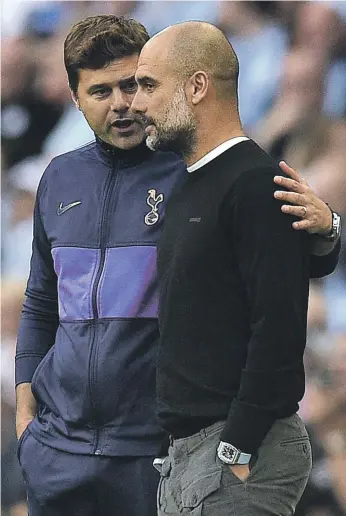  ?? AFP ?? The then Tottenham Hotspur manager Mauricio Pochettino, left, speaking to his Manchester City counterpar­t Pep Guardiola during a Premier League match in 2019