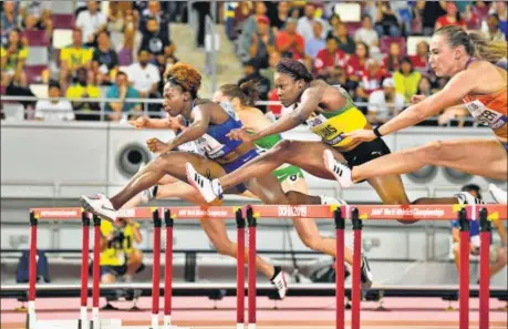  ??  ?? American Nia Ali (top, in blue) claimed her maiden World Championsh­ips gold on Sunday. (Right) Nia with her four-year-old son Titus and 16-month-old daughter Yuri. REUTERS/GETTY IMAGES