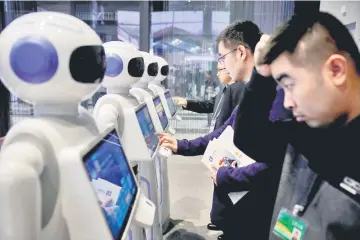  ??  ?? People look at Xiao Qiao robots during the fourth World Internet Conference in Wuzhen, Zhejiang province. — Reuters photo