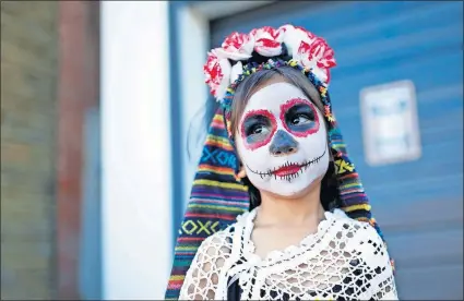  ?? ARCHIVES] [SARAH PHIPPS/ THE OKLAHOMAN ?? Imelda Nunez waits for the start of the 2017 Day of the Dead parade in the Plaza District in Oklahoma City.