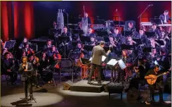  ?? ?? Portuguese fado vocalist Camane (front left) performs at a concert with the Macao Chinese Orchestra. Fado, a music genre traceable to 1820s Lisbon, Portugal, embodies themes of destiny and fate.