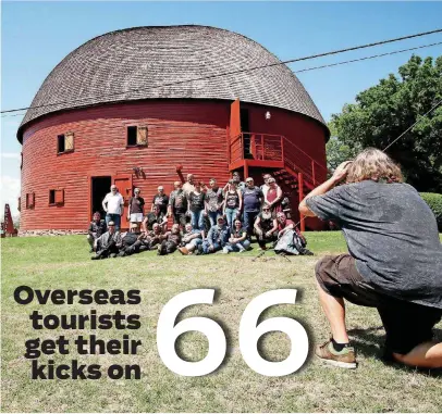  ?? [PHOTO BY DOUG HOKE, THE OKLAHOMAN] ?? Tourists from the Czech Republic pose for a group photo while visiting at the Round Barn on Route 66 in Arcadia.