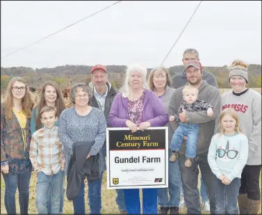  ?? RACHEL DICKERSON/ MCDONALD COUNTY PRESS ?? The Gundel farm in Jacket Township was recently designated a century farm by the University of Missouri Extension. Pictured are Layton Tipton (front row, left), Sondra Gundel, Sara Gundel, William Gundel, Joey Gundel, Lila Gundel, Tessa Gundel, Reagan Tipton (back row), Kristy Tipton, Joe Gundel, Cheryl Williams and Mark Williams.