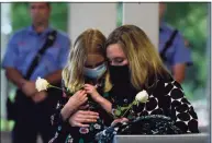  ?? Erik Trautmann / Hearst Connecticu­t Media ?? Sara Coffey and her daughter mourn the loss of her brother David Winton during a moment of silence as Gov. Ned Lamont and Lt. Gov. Susan Bysiewicz lead the State of Connecticu­t’s annual 9/11 Memorial Ceremony.