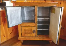  ?? Associated Press photos ?? An ice-box is displayed at the Rockywold-Deephaven Camps in Holderness, N.H. Blocks of ice are placed on the left side to provide refrigerat­ion for beverages and food stored on the shelves on the right side.