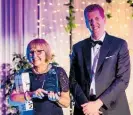  ??  ?? Jane McComb, co-owner of Kauri Coast Top 10 Holiday Park receiving the Supreme Park award at TOP 10’s gala awards evening in Auckland. Presenting the award is Todd Moyle, KiwiRail acting chief executive.