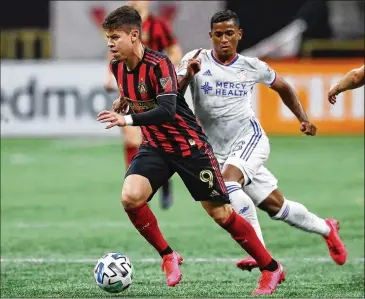  ?? CURTIS COMPTON / CCOMPTON@AJC.COM ?? Atlanta United midfielder Matheus Rossetto works against FC Cincinnati in a win March 7. “My goals are to win titles,” Rossetto said with the help of an interprete­r on a Zoom call while in Orlando, Florida.