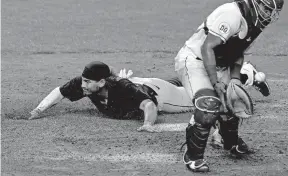  ?? [CHARLIE RIEDEL/ASSOCIATED PRESS] ?? The Indians’ Josh Naylor scores past Royals catcher Meibrys Viloria in a game on Tuesday, the day after he acquired in a trade from the Padres.