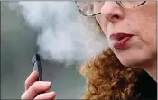  ?? (AP Photo/Craig Mitchelldy­er, File) ?? A woman exhales while vaping from a Juul pen e-cigarette in Vancouver, Wash., April 16, 2019. Federal health officials on Thursday,June 23, 2022 ordered Juul to pull its electronic cigarettes from the U.S. market, the latest blow to the embattled company widely blamed for sparking a national surge in teen vaping.