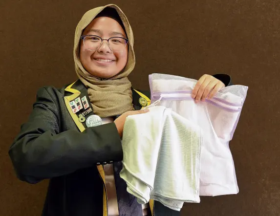  ?? PHOTO: LINDA ROBERTSON ?? Creating confidence . . . Bayfield High School head girl Sofea Haizal models the hijabs her business Piller has created from merinobase­d fabrics.