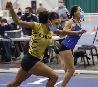  ??  ?? PHOTO FINISH: Katharine Duren, right, edged out Peyton Rollins to win the 55-meter hurdles by 0.01 seconds.