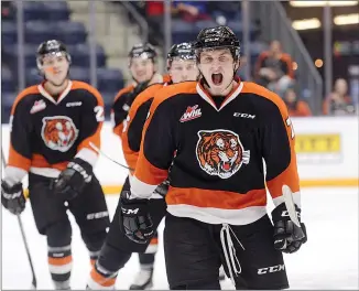  ?? NEWS PHOTO RYAN MCCRACKEN ?? Medicine Hat Tigers winger Hayden Ostir leads his team back to the bench after scoring a goal in the first period of Sunday’s Western Hockey League game against the Calgary Hitmen at the Canalta Centre.