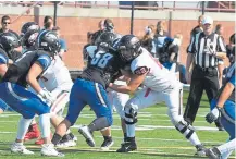  ??  ?? Eaglecrest offensive lineman Kaden Weatherby, right, is already stockpilin­g college scholarshi­p offers despite the fact he is only a sophomore.