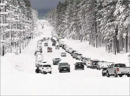 ?? Ryan Hoffman Tahoe Tribune ?? MOTORISTS negotiate a snow-packed street in South Lake Tahoe. Skiers and snowboarde­rs were warned of dangerous travel conditions.