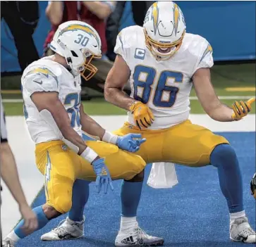  ?? Robert Gauthier Los Angeles Times ?? THE CHARGERS’ new coach will inherit a roster with upper- level talent, including that of running back Austin Ekeler, left, and tight end Hunter Henry, celebratin­g by air guitar a touchdown against Carolina.