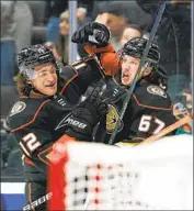  ?? Jae C. Hong Associated Press ?? THE DUCKS’ Rickard Rakell (67), with Sonny Milano, is pumped after scoring in the second period.