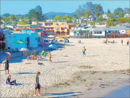  ?? Photograph­s by Mike Morris ?? CAPITOLA BEACH is a low-key refuge near Santa Cruz where you can rent paddleboar­ds or just relax on the sand.