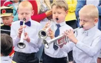  ??  ?? Youngsters take part in the dancing, above left , and trumpeters Max, Robin and Leo tuning up