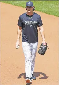  ?? Kathy Willens / Associated Press ?? New York Yankees starting pitcher Gerrit Cole walks on the field before a baseball summer training camp workout on Sunday at Yankee Stadium in New York.