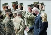  ?? MANUEL BALCE CENETA — THE ASSOCIATED PRESS ?? President Joe Biden holds a presidenti­al challenge coin as he speaks with Air Force Mortuary Affairs Operations Air Force Col. Chip Hollinger and others after participat­ing in a casualty return Sunday, at Dover Air Force Base.