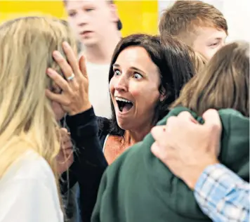  ??  ?? A mother’s joyous reaction to her child’s GCSE results at Solihull School, near Birmingham, where the new exams were taken