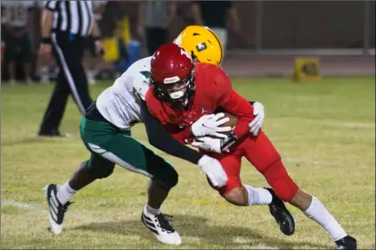  ?? PHOTO SERGIO BASTIDAS ?? Imperial High’s Jesse Nichols runs the ball against Holtville High during a football game on Friday night in Imperial.