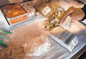  ??  ?? A health worker puts together “harm-reduction” kits for heroin addicts inside a needleexch­ange van in Southwest Baltimore.