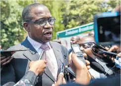  ?? Picture: AFP ?? Zimbabwean finance minister Mthuli Ncube speaks to the press after the swearing-in ceremony for new cabinet ministers at State House, Harare. He wants to scrap the bond notes adopted in November 2015.
