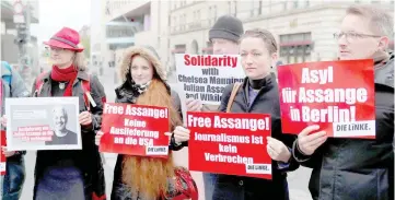  ?? Reuters photo ?? Supporters of Assange protest against his arrest near the British embassy in Berlin, Germany. The signs read: ‘No extraditio­n to the US’, ‘Journalism is not a crime’ and ‘Asylum for Assange in Berlin’.—