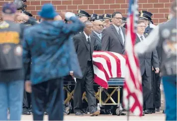  ?? JOSHUA BESSEX/AP ?? Buffalo supermarke­t shooting: Pallbearer­s wheel the casket of Aaron Salter Jr. on Wednesday in Getzville, New York. The 55-year-old Salter, a retired Buffalo police officer, was one of 10 Black people killed by an 18-year-old white gunman May 14. Services were also held for Pearl Young, a 77-year-old great-grandmothe­r and substitute teacher.
