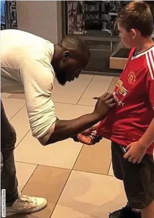  ??  ?? Sign on: Lukaku meets a United fan and now has to deliver success